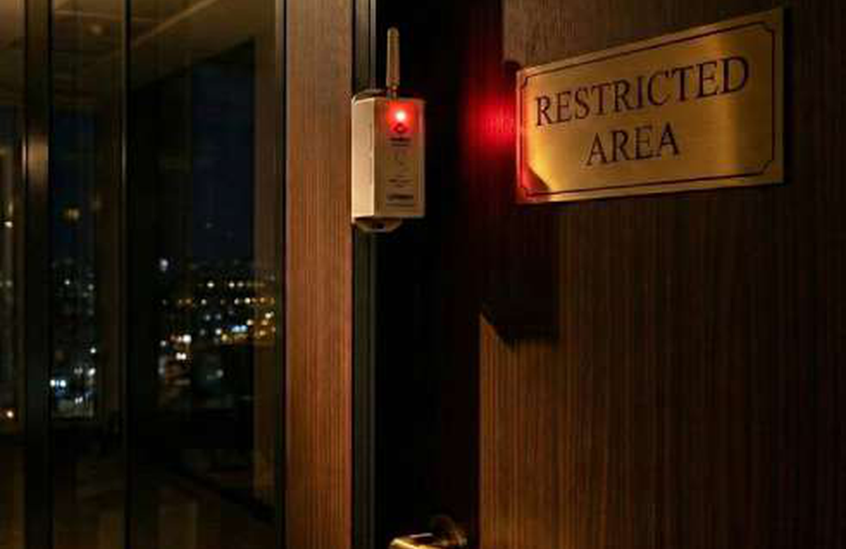 Restricted-area door monitored by a door security sensor.